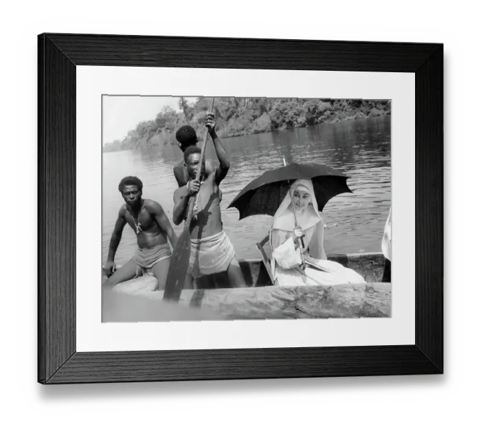 Framed Print : Audrey Hepburn With Natives On Canoe Framed Print : Audrey Hepburn With Natives On Canoe