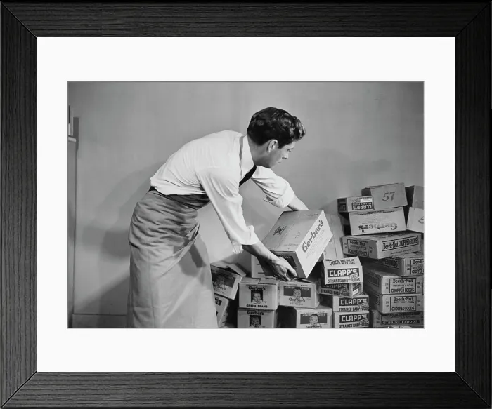 Framed Print : Baby Food. A man moving boxes of Gerber's and Clapp's tinned baby food Framed Print : Baby Food. A man moving boxes of Gerber's and Clapp's tinned baby food
