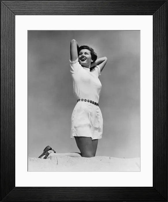 Framed Print : Beachwear. A young woman modelling a beach outfit of cotton top and shorts, circa 1955 Framed Print : Beachwear. A young woman modelling a beach outfit of cotton top and shorts, circa 1955