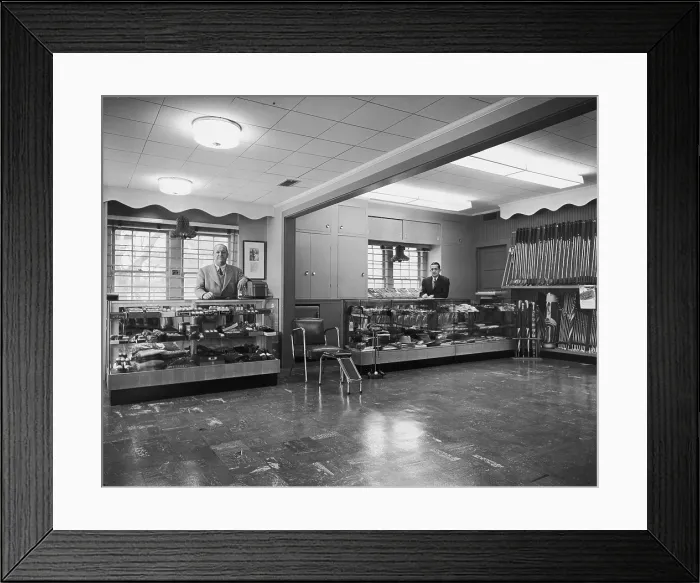 Framed Print : Shop Assistants In Sporting Goods Store Framed Print : Shop Assistants In Sporting Goods Store