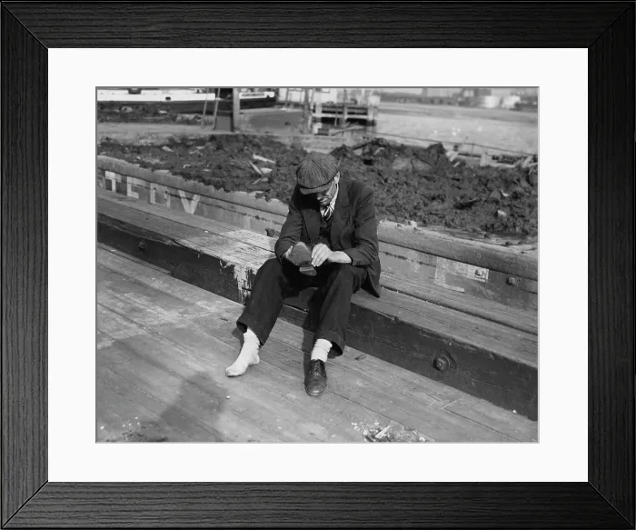 Framed Print : One Shoe. A man in a suit sits down to take off his shoe, circa 1935 Framed Print : One Shoe. A man in a suit sits down to take off his shoe, circa 1935