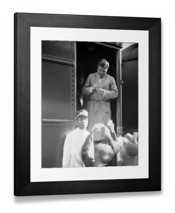 Framed Print : Babe Ruth, wearing dressing gown, stands in the doorway of a train Framed Print : Babe Ruth, wearing dressing gown, stands in the doorway of a train