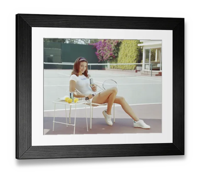 Framed Print : Woman in tennis outfit holding drink can, smiling, portrait Framed Print : Woman in tennis outfit holding drink can, smiling, portrait