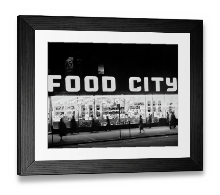 Framed Print : Food City. Pedestrians on the sidewalk pass the illuminated windows of a Food City store Framed Print : Food City. Pedestrians on the sidewalk pass the illuminated windows of a Food City store