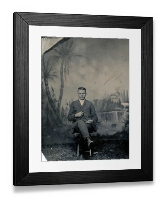 Framed Print : Tintype portrait of young man in portrait studio with tropical painted backdrop, circa 1870s Framed Print : Tintype portrait of young man in portrait studio with tropical painted backdrop, circa 1870s