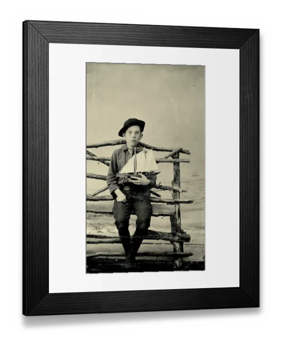 Framed Print : Tintype photograph from 1870s of boy holding a model sailboat Framed Print : Tintype photograph from 1870s of boy holding a model sailboat