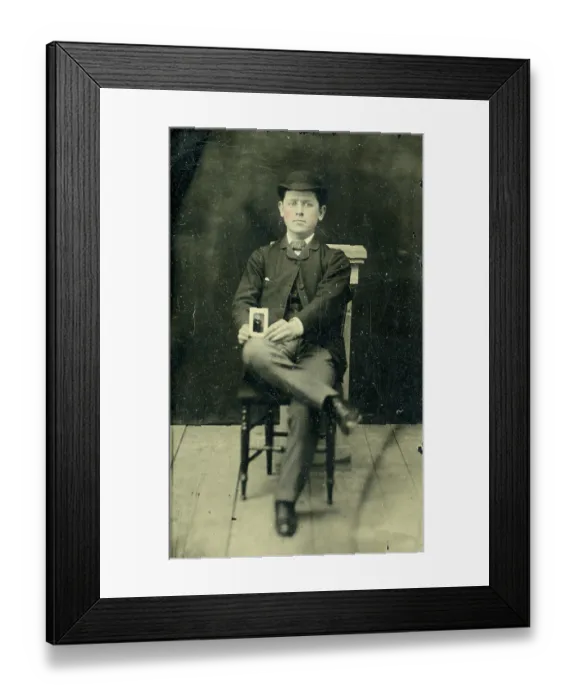 Framed Print : Tinype of young man holding a photograph Framed Print : Tinype of young man holding a photograph