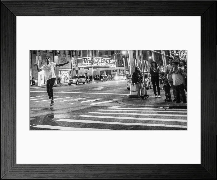 Framed Print : Man dancing in the street down the street from Radio City Music Hall