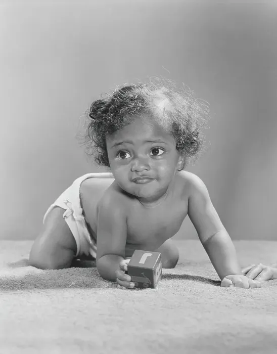 Framed Print : 14 month old African-American baby holding alphabet block, crawling, close-up Framed Print : 14 month old African-American baby holding alphabet block, crawling, close-up