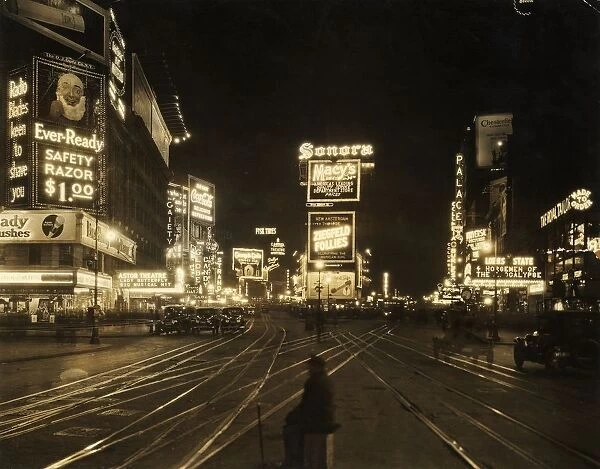 1921 View of the traffic and illuminated advertisements in Times Square at night