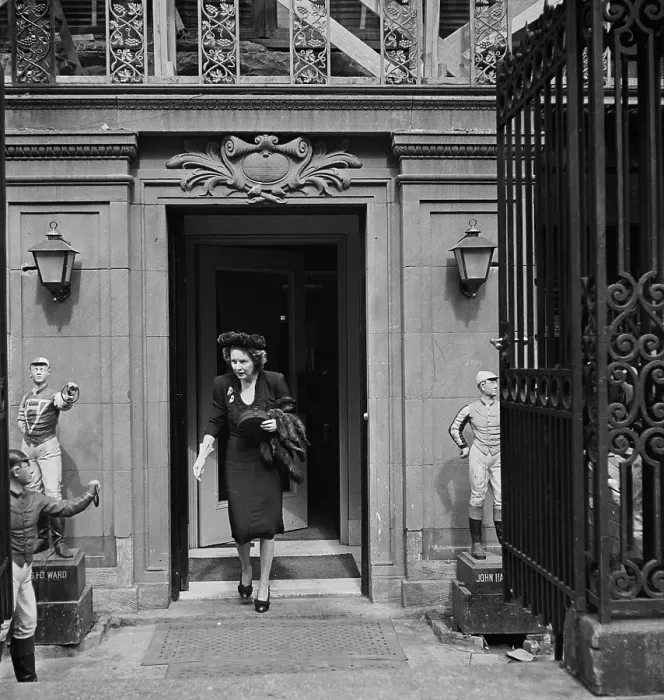 Framed Print : 21 Club. A woman leaving the 21 Club, restaurant on West 52nd Street in New York City Framed Print : 21 Club. A woman leaving the 21 Club, restaurant on West 52nd Street in New York City