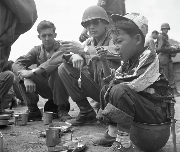 Framed Print : 24th Infantry Division's Adopted Child Al Eats With The G.I.s Framed Print : 24th Infantry Division's Adopted Child Al Eats With The G.I.s