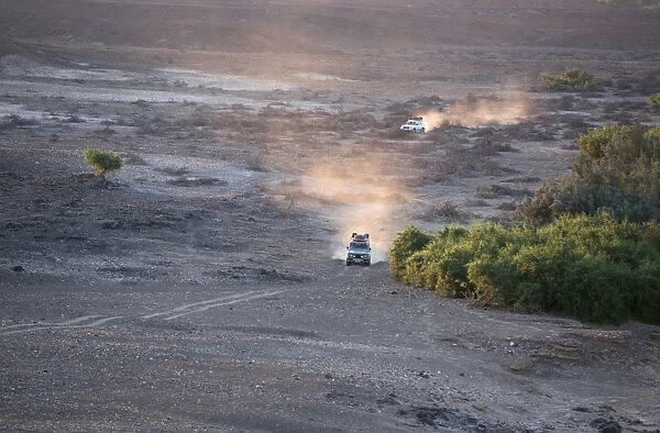 4X4 Vehicles Crossing Desert Landscape