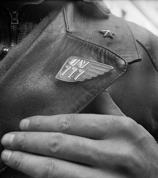 Call 777. A member of the Italian police wearing a 777 button