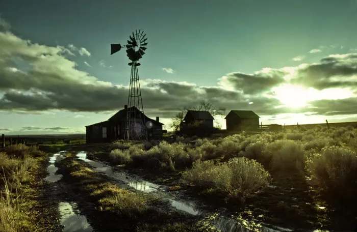 Framed Print : Abandoned homestead with windmill at sunrise