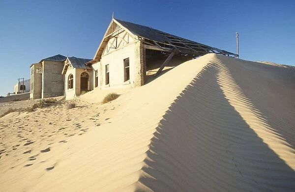 Abandoned Houses with Sand Dune in Foreground