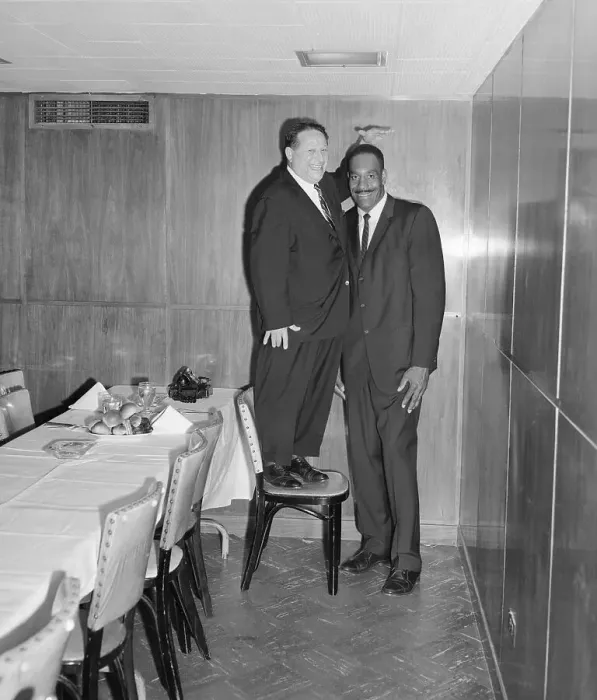 Framed Print : Abe Saperstein Posing on Chair Next to Basketball Player Nat Clifton Framed Print : Abe Saperstein Posing on Chair Next to Basketball Player Nat Clifton