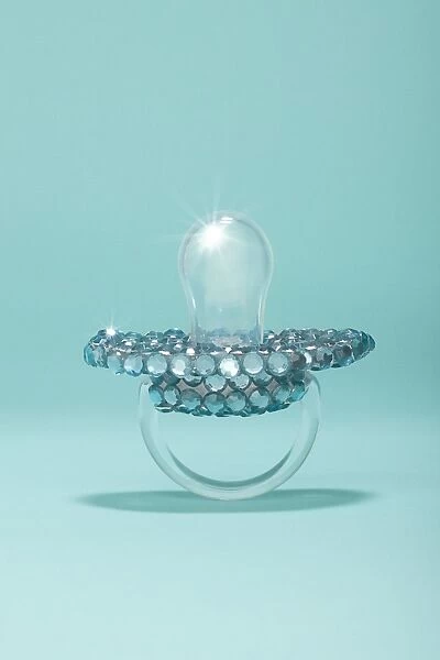 aby pacifier covered in diamonds on blue