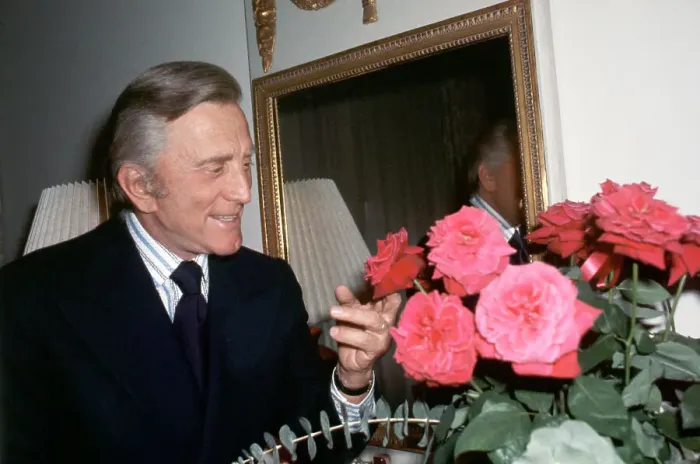 Framed Print : Actor Kirk Douglas Looking At Roses