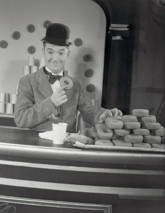 Framed Print : Actor Stan Laurel at Donut Display Framed Print : Actor Stan Laurel at Donut Display