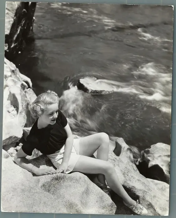 Framed Print : Actress Bette Davis Sitting on Rocks Above Water