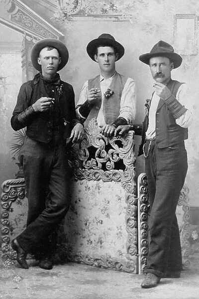 adults, archival, black & white, caucasian, cowboy hats, cowboys, drinking, eye contact