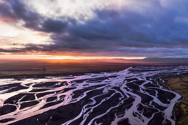 Aerial drone view of braided river and midnight sun, Iceland