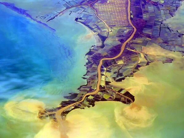 Aerial of flooding river discharging eroded soil, silt and other sediments into the Java Sea