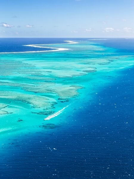Aerial of Malolo reef with motorboat passing, Fiji