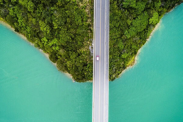 Aerial photograph of crystal clear ocean and bridge