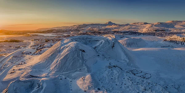 Aerial of snow covered mountains and lava