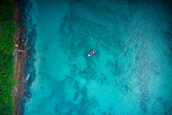 Aerial view of boat on crystal clear water in Phi Phi Island, Krabi, Thailand