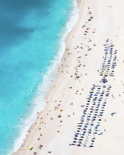Aerial view of famous Myrtos beach crowded with tourists in summer, Greece