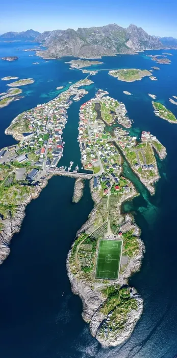 Framed Print : Aerial view, Henningsvaer with football stadium, rock islands in the sea off Bergen, Festvagtinden, Vestvagoey, Lofoten, Nordland, Norway Framed Print : Aerial view, Henningsvaer with football stadium, rock islands in the sea off Bergen, Festvagtinden, Vestvagoey, Lofoten, Nordland, Norway
