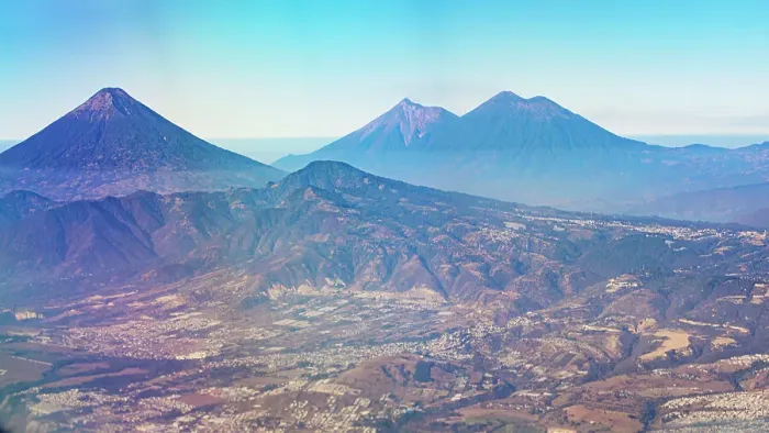 Framed Print : Aerial View of Volcanoes and Part of the Nearby City - Guatemala - Central America Framed Print : Aerial View of Volcanoes and Part of the Nearby City - Guatemala - Central America
