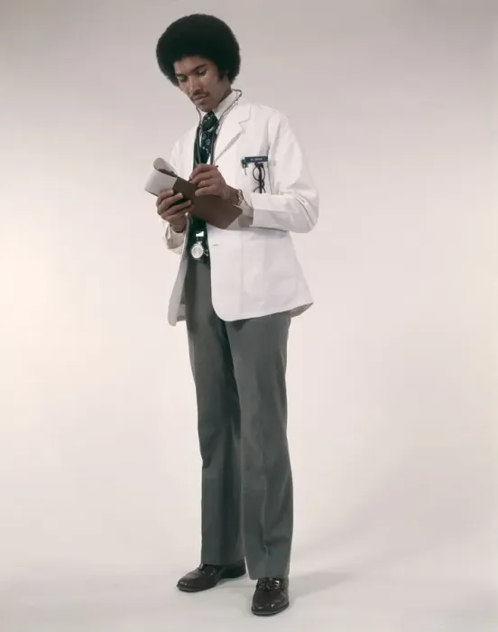 Framed Print : African-American Man Doctor Wearing White Coat And Stethoscope Writing Prescriptions