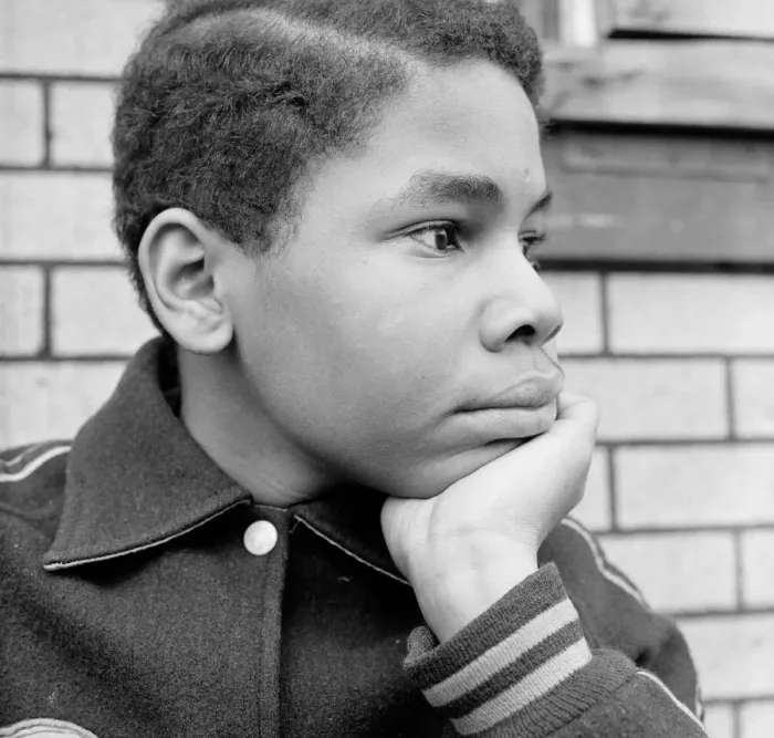 Framed Print : African-American teenage boy resting chin in hand, looking off to side Framed Print : African-American teenage boy resting chin in hand, looking off to side
