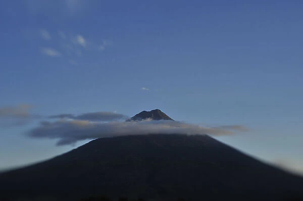 The Agua volcano ringed by clouds at dusk