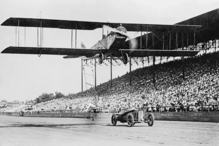 Framed Print : Air Show. A stuntperson leaps from a moving car onto a ladder dangling Framed Print : Air Show. A stuntperson leaps from a moving car onto a ladder dangling