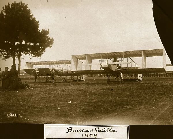 Air Meet. circa 1909: Two biplane boxkites of Farman-Voisin influence guarded