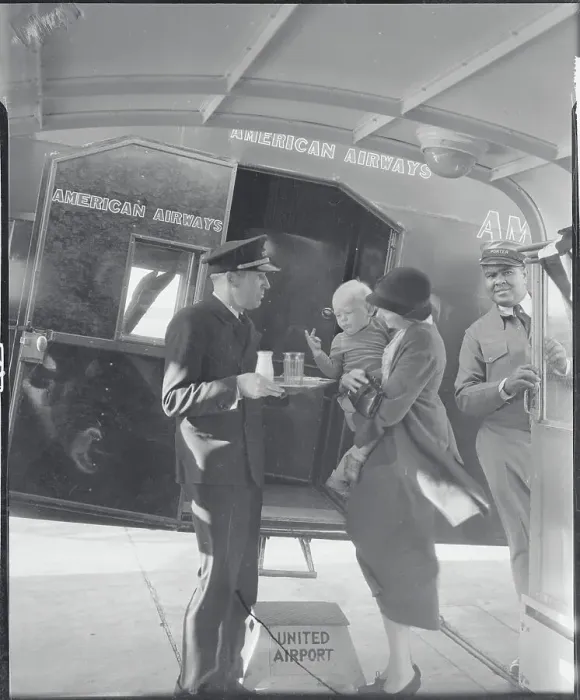 Framed Print : Air Steward Offering Milk to Baby Framed Print : Air Steward Offering Milk to Baby