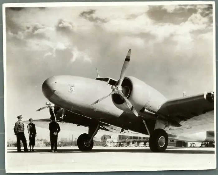 Framed Print : Airline Employees Standing Below Airplane Framed Print : Airline Employees Standing Below Airplane