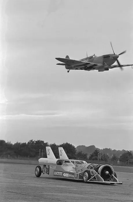 Framed Print : Airplane Flying Over Race Car in Action Framed Print : Airplane Flying Over Race Car in Action