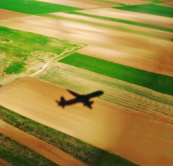 Airplane shadow on farm fields in Austria