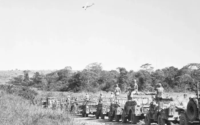 Framed Print : Airplane over Troops Traveling in Jeeps Framed Print : Airplane over Troops Traveling in Jeeps
