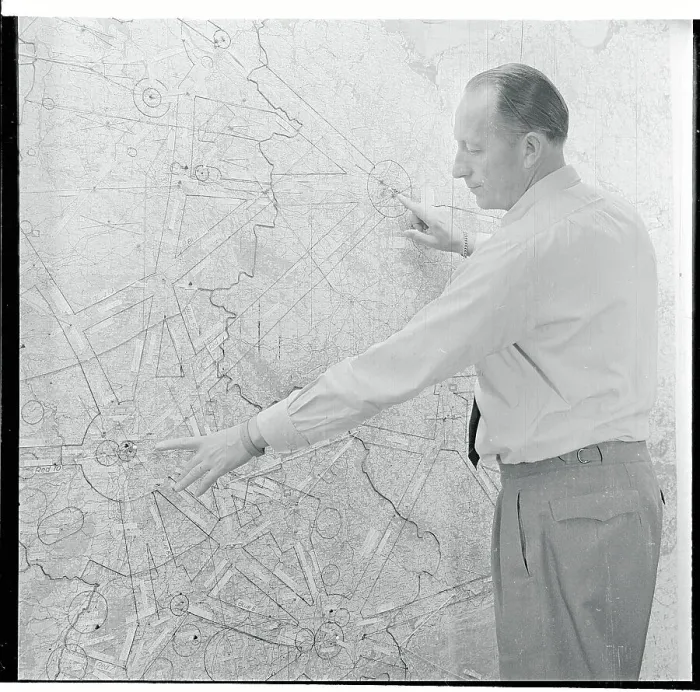 Framed Print : Airport Official Pointing to a Map Framed Print : Airport Official Pointing to a Map