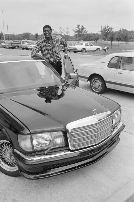 Framed Print : Akeem Olajuwon Standing by Car Framed Print : Akeem Olajuwon Standing by Car