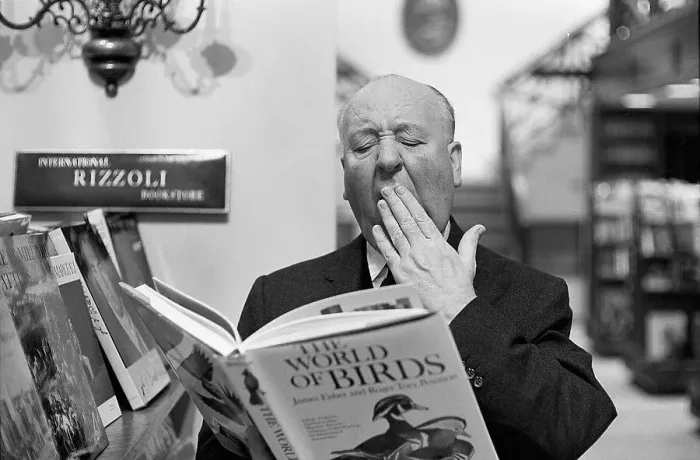 Framed Print : Alfred Hitchcock Yawning over Book of Birds Framed Print : Alfred Hitchcock Yawning over Book of Birds