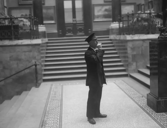 Framed Print : All Out. December 1927: A museum guard in the National Gallery blows his whistle Framed Print : All Out. December 1927: A museum guard in the National Gallery blows his whistle