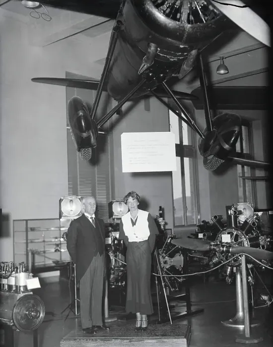 Framed Print : Amelia Earhart and Orville Wright Posing Near Displayed Airplane Framed Print : Amelia Earhart and Orville Wright Posing Near Displayed Airplane